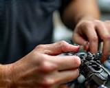 Worker carefully assembling small bicycle components by hand.