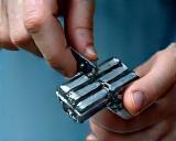 Quality control engineer using a caliper to measure a finished component.